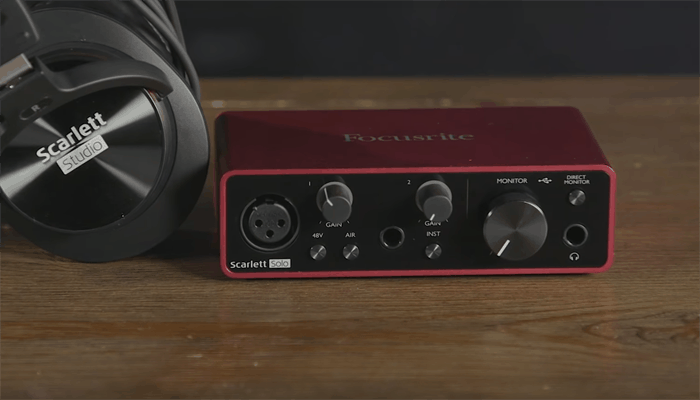 The Scarlet Solo on a desk with a set of Scarlet Studio headphones